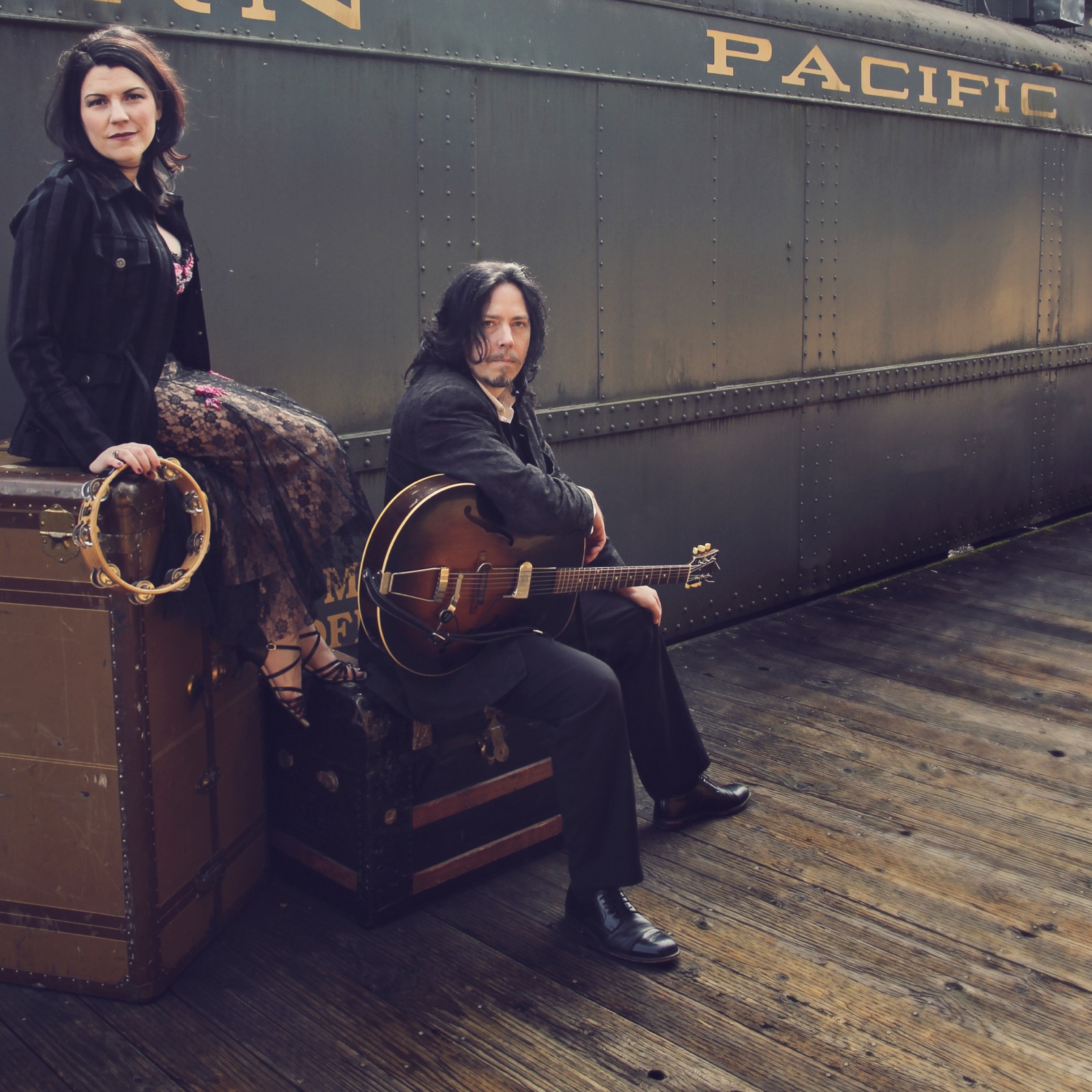 Jackie and Jason at the train station with instruments
